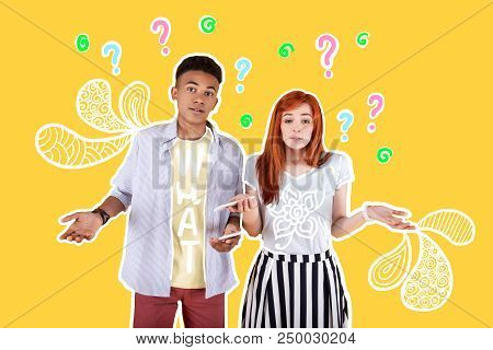 Many Questions. Emotional Friendly Students Standing Together With Modern Smartphones In Their Hands