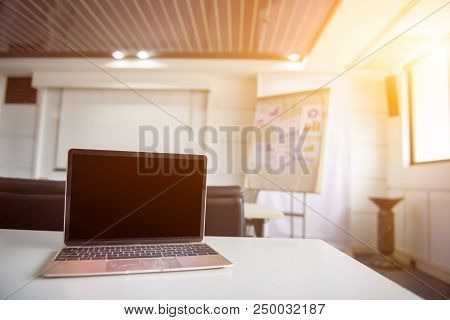 Laptop On The Table In The Meeting Room. Fintech And Technology