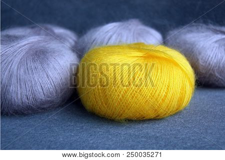 Yellow And Gray Yarn Balls Of Mohair (angora) For Knitting On The Velvet Background