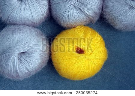 Yellow And Gray Yarn Balls Of Mohair (angora) Wool For Knitting On The Velvet Background