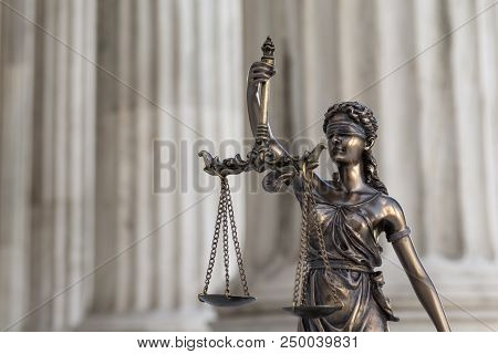 The Statue Of Justice Themis Or Iustitia, The Blindfolded Goddess Of Justice Against An Ionic Order 