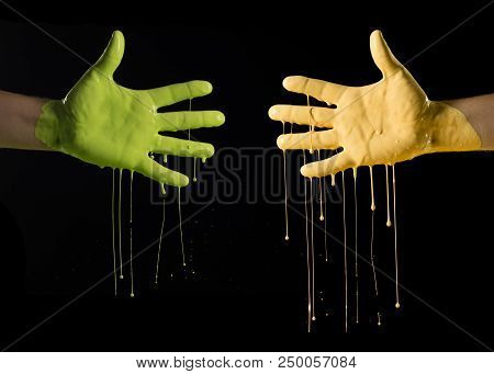 Elegant Male Hand On A Light Paint Isolated On A Black Background.