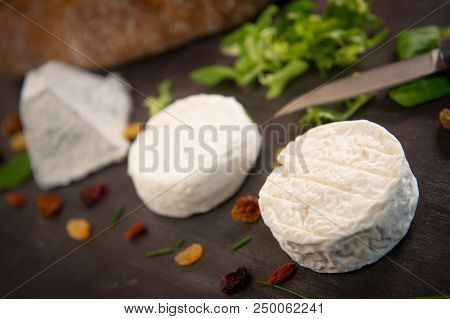 French Goats Cheeses And Bread On Background