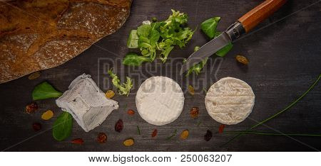 French Goats Cheeses And Bread On Background