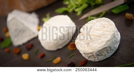 French Goats Cheeses And Bread On Background