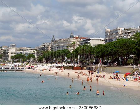 Cannes, France - June 28, 2018: Vacationers Enjoy The Beautiful Weather At The Public Beach At The E