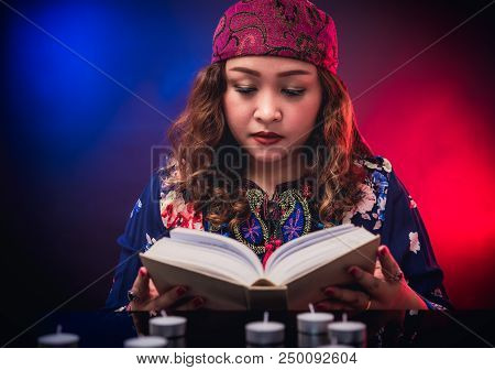 Female Seer Teller Doing Psychic Reading Book For Predicting Fate