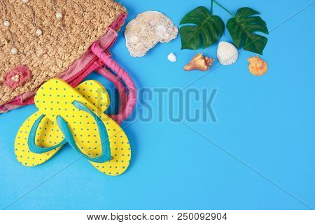 Yellow Sandals With Woven Handbags On Blue Color Background, Summer Holidays Accessories . Flat Lay 