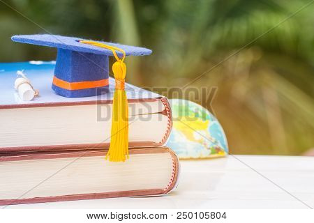 Graduate Or Education Knowledge Learning Study Abroad Concept : Blue Graduation Cap On Textbook With