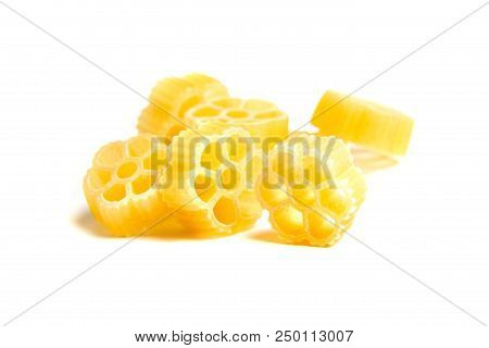 Raw Uncooked Rotelle Dry Italian Pasta. Ruote, Wagon Wheel Shaped. Heap, Isolated On White Backgroun