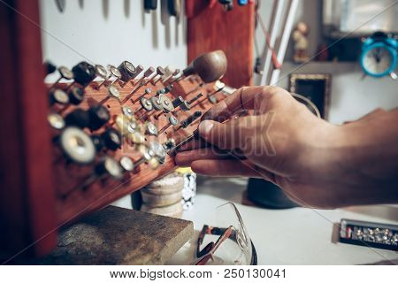 Different Goldsmiths Tools On The Jewelry Workplace. Jeweler At Work In Jewelry. Desktop For Craft J