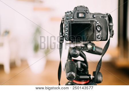 Dslr Camera Sitting On Tripod And Taking Photographs. Interior Design Photography Gear