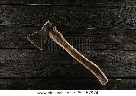 Top View Of Vintage Axe On Wooden Tabletop Background