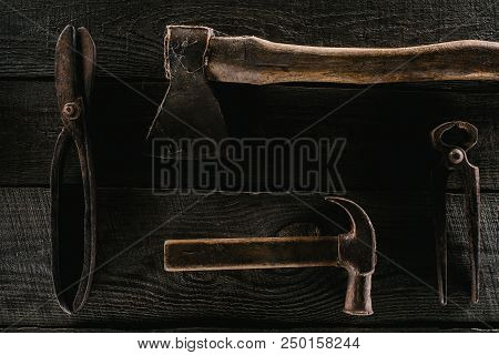 Flat Lay With Arranged Vintage Axe, Pliers, Scissors And Hammer On Wooden Surface