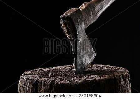 Close Up View Of Vintage Axe On Wooden Stump Isolated On Black