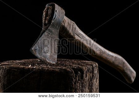 Close Up View Of Vintage Axe On Wooden Stump Isolated On Black