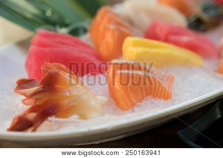 Mixed Sliced Fish Sashimi On Ice In White Bowl. Sashimi Salmon Tuna Hamachi Prawn And Surf Calm Set,