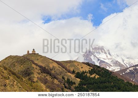 View On The Mount Kazbek And Gergeti Trinity Church (tsminda Sameba), Holy Trinity Church Near The V
