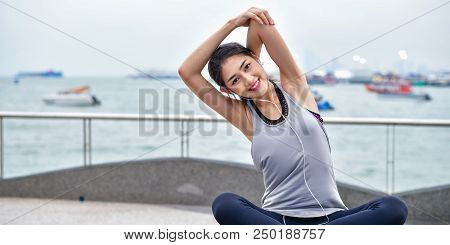 Sports Concept. Beautiful Girl Is Exercising On The Beach With Warm Up. Beautiful Girl Is Happy To E