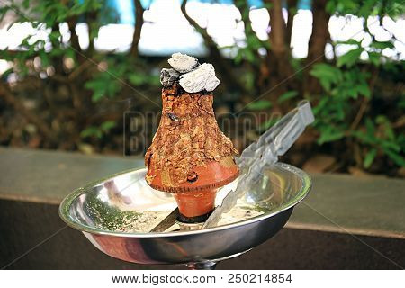 Ajami Tobacco Leaves Burning In A Hookah Head.