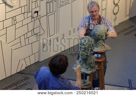 ST. PETERSBURG, RUSSIA - JULY 15, 2018: Sculptors Oleg Shorov (left) and Oleg Zhenilenko participate in artistic battle during the opening of festival Laboratory Of Sculpture in the museum workshop