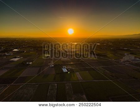 View From The Air To The Agrarian Fields During A Bright Sunset Near The Bays Of Port Saplaya. Valen