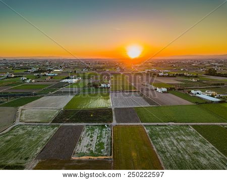 View From The Air To The Agrarian Fields During A Bright Sunset Near The Bays Of Port Saplaya. Valen
