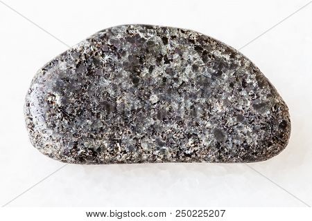 Macro Shooting Of Natural Rock Specimen - Tumbled Peridotite Stone With Phlogopite Mica On White Mar