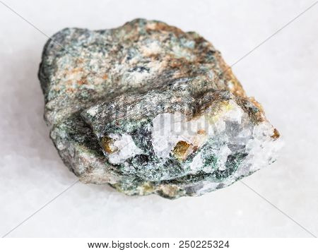 Macro Shooting Of Natural Mineral - Chrysoberyl Crystals In Raw Beryl Rock On White Marble From Ural