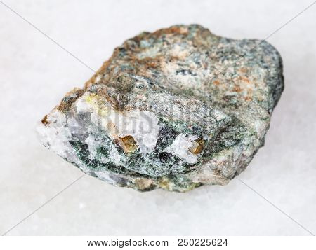 Macro Shooting Of Natural Mineral - Chrysoberyl Crystals In Rough Beryl Rock On White Marble From Ur