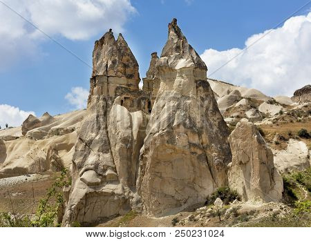 Stone Conical Houses In The Ancient Rocks Of Goreme, Cappadocia. Rural Landscape In The Rural Way Of
