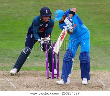 LEEDS, ENGLAND - JULY 17: Virat Kohli of India is bowled out as wicketkeeper Jos Buttler of England looks on during the 3rd Royal London One day International match between England and India at Headin