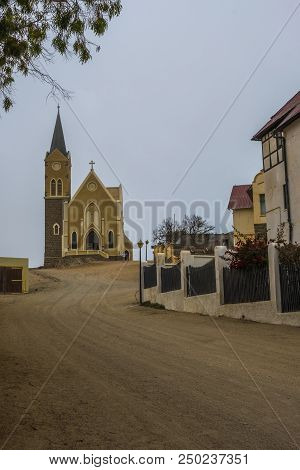 Luderitz, Namibia - March 23 2018: Looking Up Street In Luderitz To Iconic Evangelical Lutheran Fels