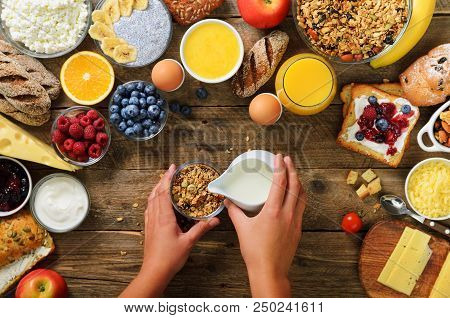 Girl Cooking Breakfast - Granola With Yogurt, Fruits, Berries, Milk, Yogurt, Juice, Cheese. Top View
