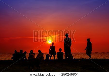 Silhouette Woman Standing With Family Looking Sunset On Beach