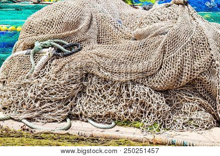 Portrait Of Various Types And Sizes And Colors Of Fishing Nets, Piled Up In A Fishing Port.