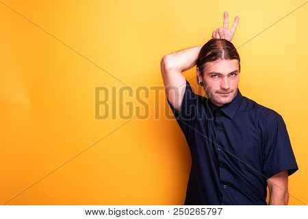 Male Adult Showing Funny Peace Sign. Funny Gestures In The Studio