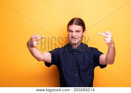 Rude Male Portrait Showing Two Middle Fingers. Studio Captured Emotions