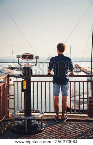 Odessa, Ukraine - August 06, 2015: Young Man Looking Forward From The Hi Spy Viewing Machine Watchin