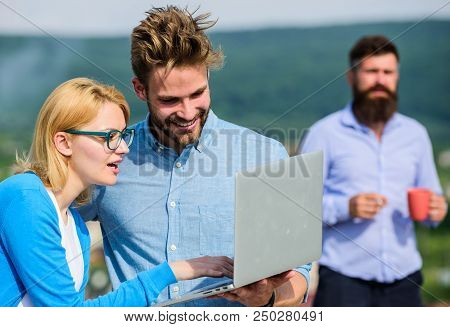 Colleagues Working Laptop, Boss Smoking While Coffee Break On Background. Couple Works Despite Of Co