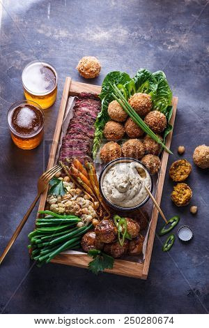 Pastrami, Falafel, Babagahanoush, Veggies And Beer In A Wooden Box, Copyspace