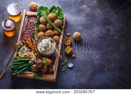 Pastrami, Falafel, Babagahanoush, Veggies And Beer In A Wooden Box, Copyspace