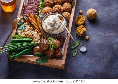 Close View Of Assorted Meze Appetizers Beef, Falafel, Babaghanoush, Potatoes In A Box, Copyspace