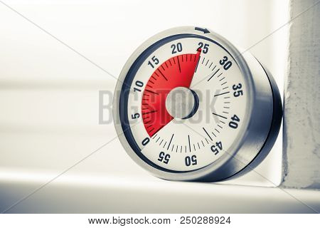 25 Minutes - An Analog Kitchen Timer With Red Mark Placed On A Window Sill In Monochrome Colors