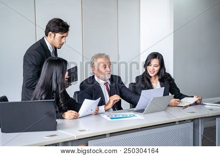 group of successful businessman. Discussion of the business profits of the company in meeting roon o