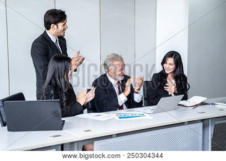 group of successful businessman. Discussion of the business profits of the company in meeting roon o