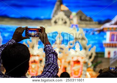 Durgapur, West Bengal, India. July, 2018 A Devotee Clicking Photo Of Idols Of Jagannath Balaram Suva