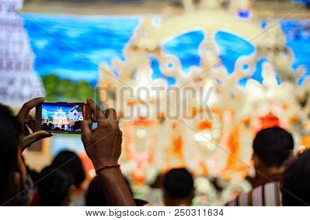 Durgapur, West Bengal, India. July, 2018 A Devotee Clicking Photo Of Idols Of Jagannath Balaram Suva