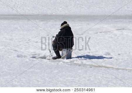 Winter Fishing. River, Lake Near Forest In Ice. Anglers, Fishermens During Your Favorite Leisure Tim
