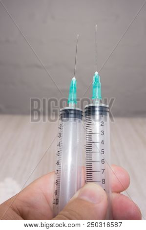 White Pill And Syringe On A Gray Background.2 Syringes And A Yellow Injector Solution On A Gray Back